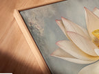 Close up of a canvas print in a floating frame. The Lotus Flower artwork adds modern elegance. This botanical wall art is perfect for a bedroom spa or living room. Bring calming zen to your home.