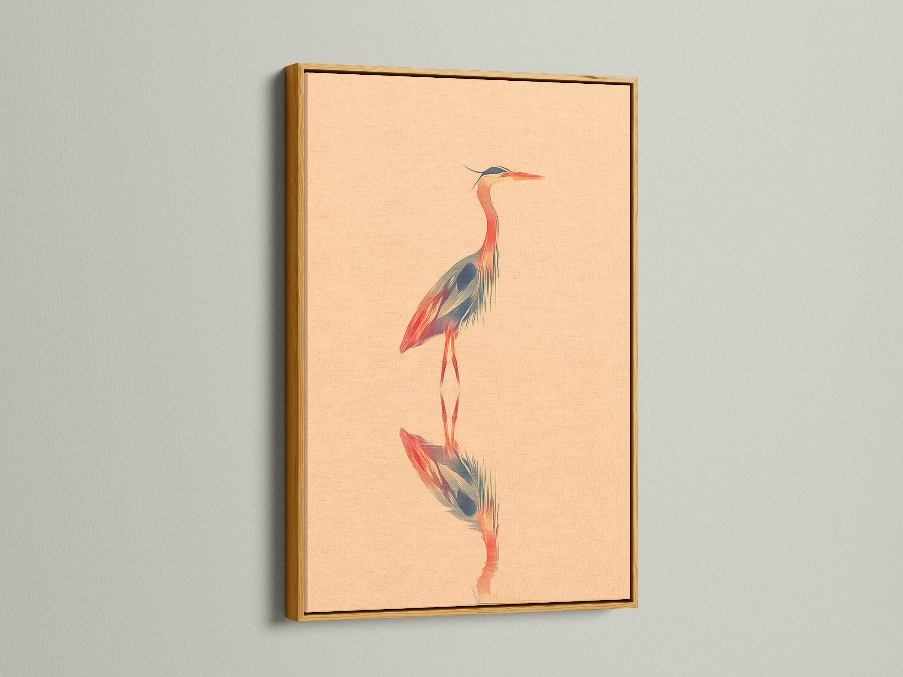 Gold frame featuring heron artwork. The elegant frame enhances the bird canvas print. The peach wall art adds warmth to any room. This coastal wall art is a modern minimalist piece. It is perfect for lake house decor.