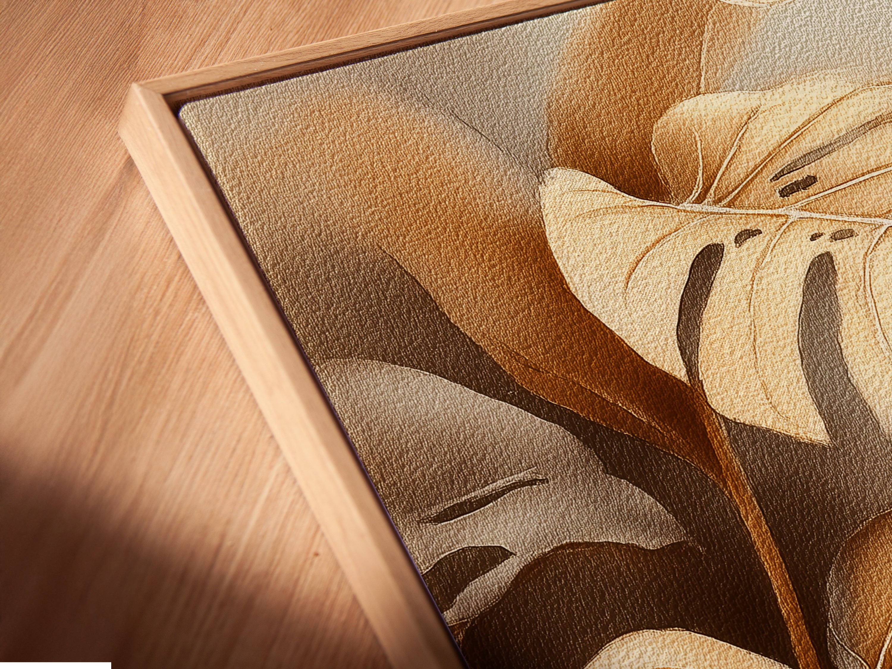 Close-up angled view of a canvas print in a floating frame. This monstera art highlights the details and texture. The botanical print appears to float adding depth. Its modern aesthetic enhances any wall decor. This neutral plant art complements various styles.