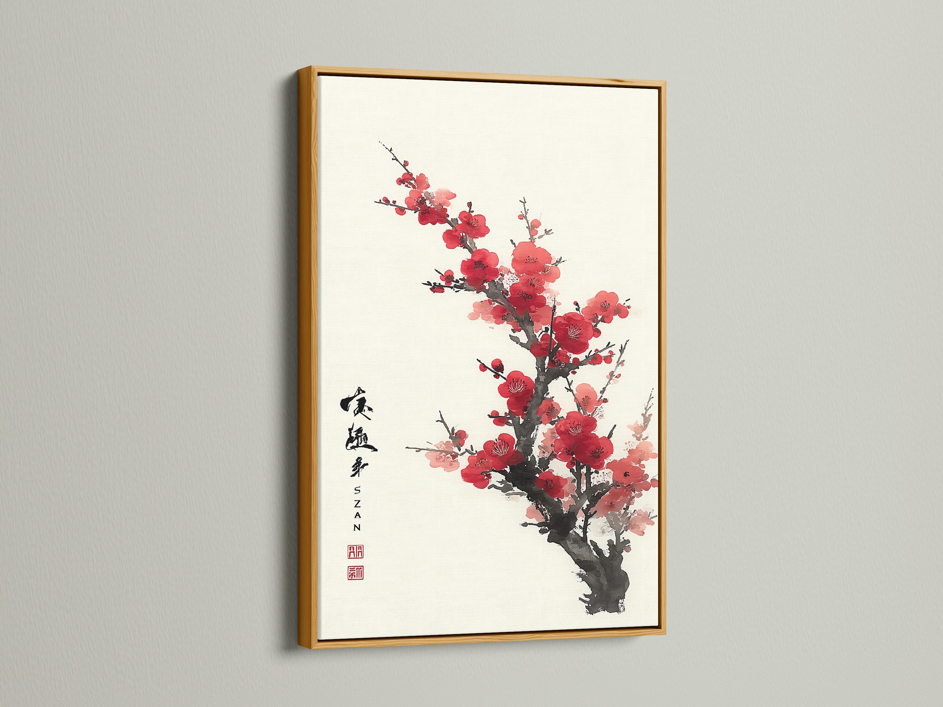 Artwork featuring red blossoms in a gold frame. The artwork is hung on a white wall. The golden frame adds a touch of luxury. Elevate your space with framed artwork. Discover our range of frame options. Find the perfect piece to complement your style.