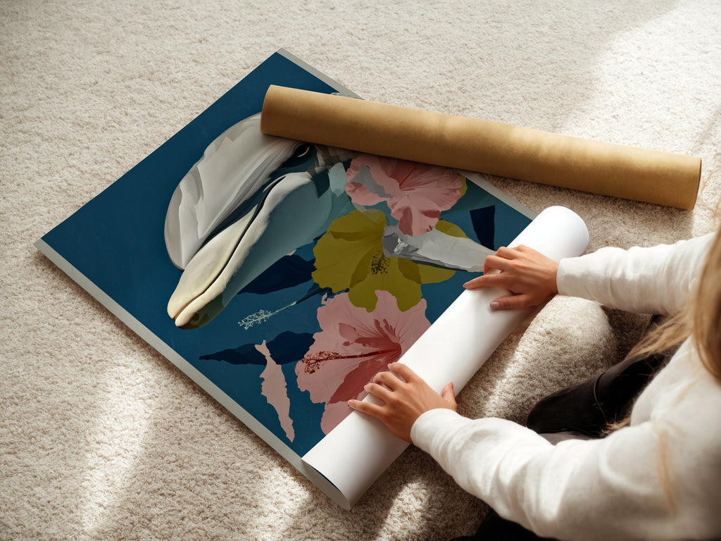 A woman rolling a fine art poster paper. This is a whale botanical art print. This tropical hibiscus canvas print is perfect for coastal bedroom decor. The ocean animal wall art is a great addition to any room.