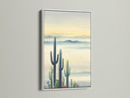 Southwestern Decor in a White Frame. This cactus artwork features a desert landscape. The white frame accentuates the modern wall decor. It is suitable for bedroom wall decor or as a statement piece. The botanical print adds a touch of arid scenery.