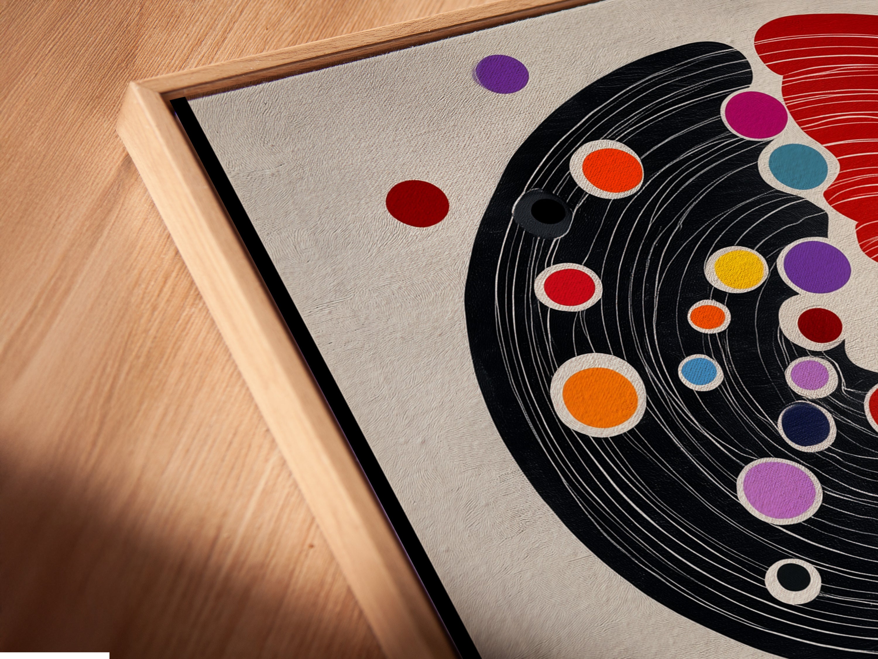 A close-up angled view of a canvas print in a floating frame. The Abstract Tree Artwork is modern and geometric. The artwork is a red and black minimalist print. This stylish framing option enhances any artwork.