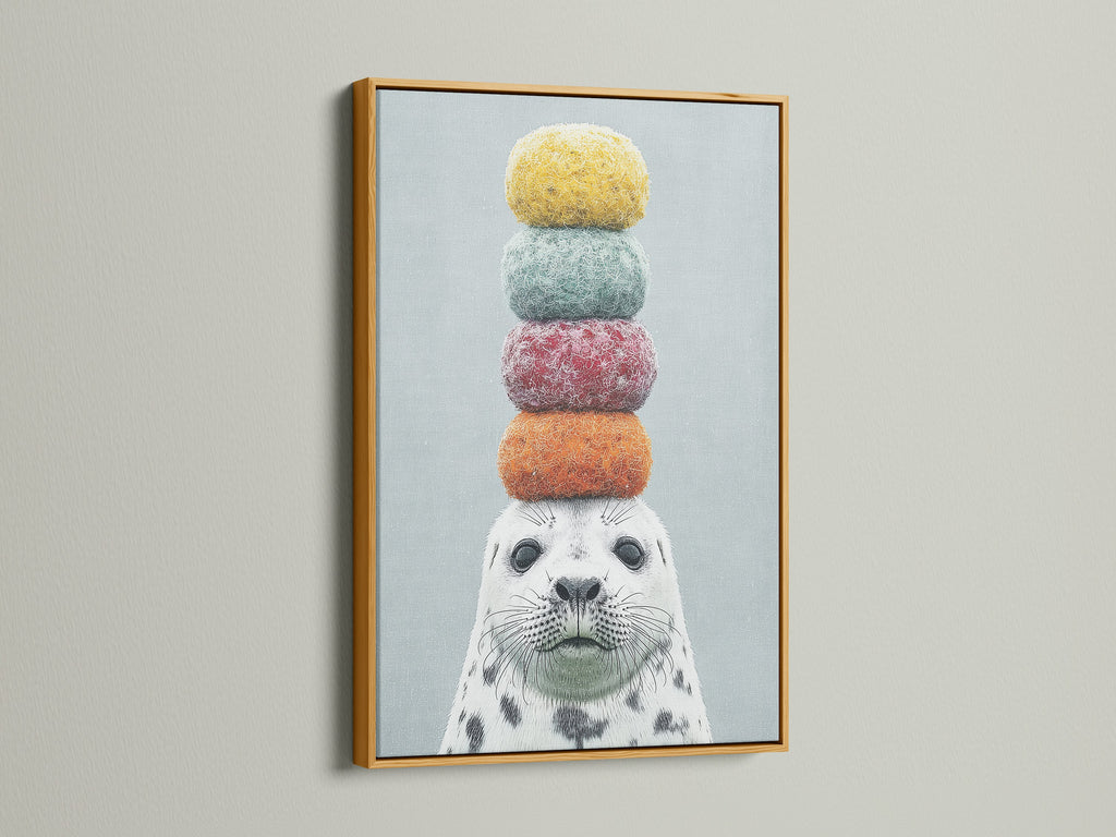 The charming seal artwork with macarons is highlighted by a gold frame. A touch of elegance to this playful animal art. Perfect for adding a whimsical touch to any room. This colorful canvas print is a delightful choice for nursery or kids room decor.