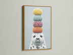 The charming seal artwork with macarons is highlighted by a gold frame. A touch of elegance to this playful animal art. Perfect for adding a whimsical touch to any room. This colorful canvas print is a delightful choice for nursery or kids room decor.