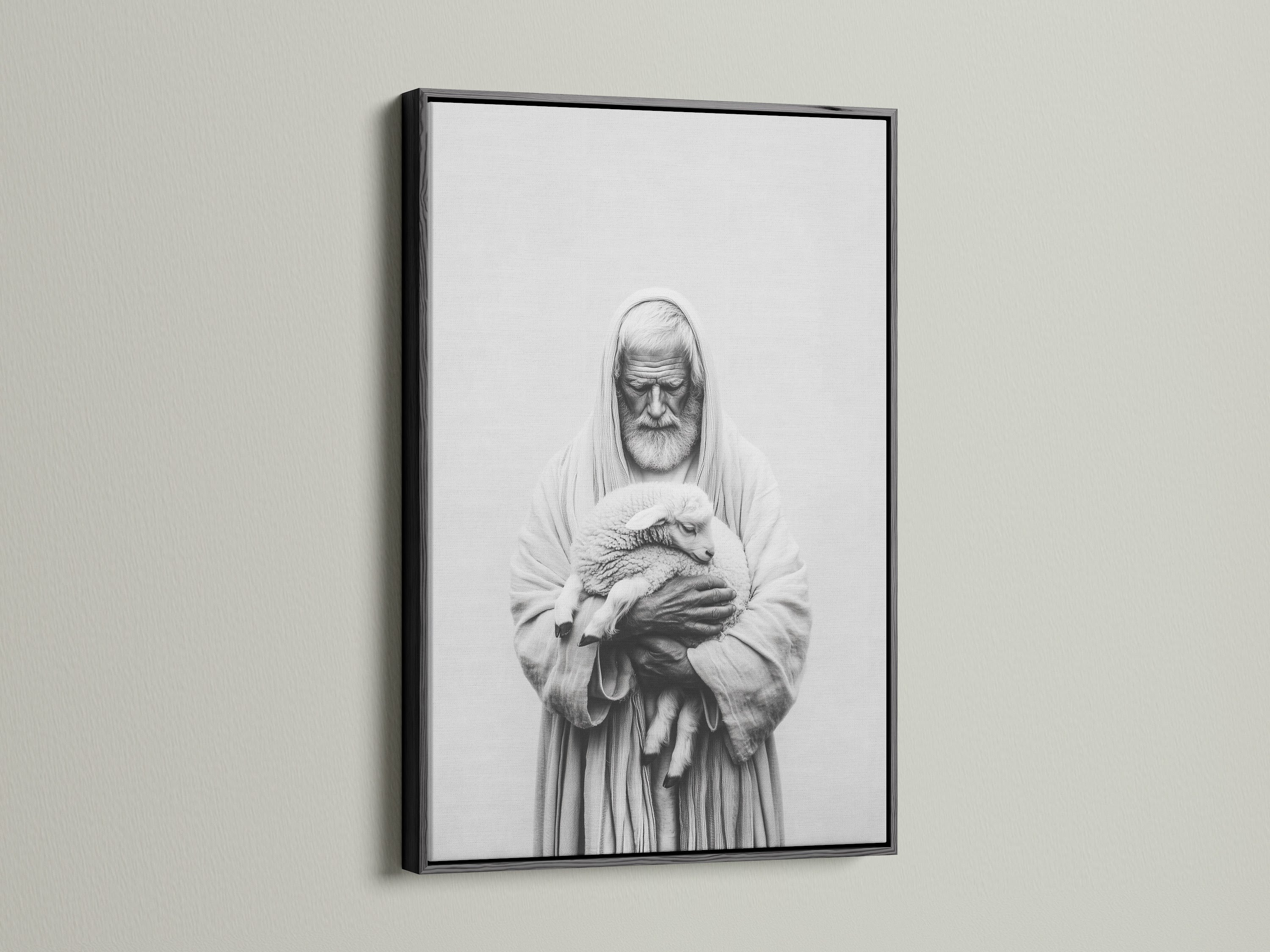 A framed artwork hangs on a light beige wall. The artwork has a black frame. The frame is thin and modern. The art print is a black and white image of a man holding a lamb. This artwork adds a touch of elegance to your home.