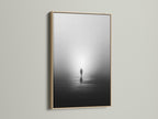 This is a serene minimalist solitude canvas print. The artwork features a foggy water reflection wall art. It is framed in a light oak. It enhances modern photography in any space.