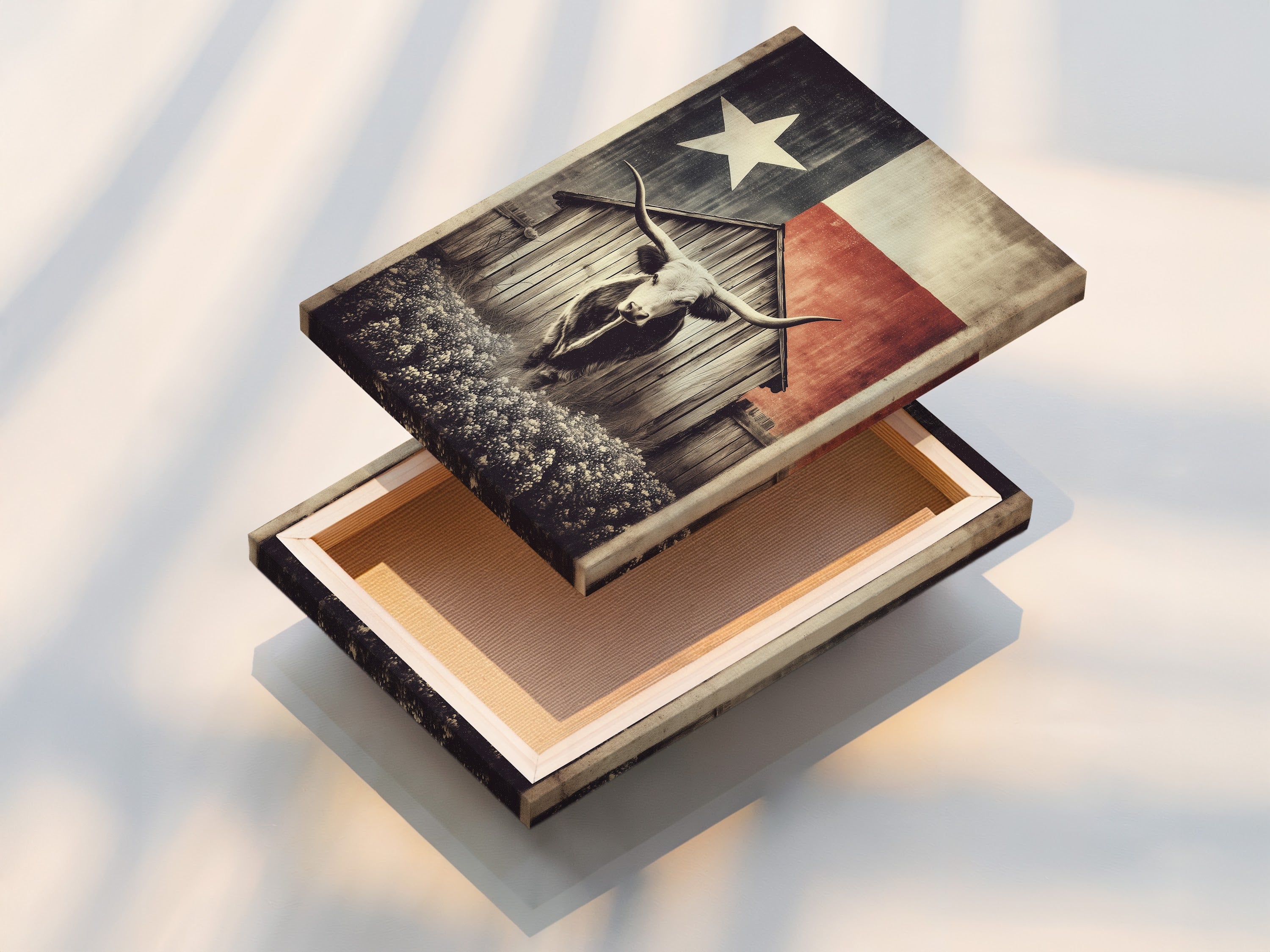 A stretched canvas print featuring Texas Longhorn art. The artwork showcases a longhorn in front of a wooden barn. A Texas flag is behind the barn. This rustic farm wall art will bring vintage western decor to any room. Display it proudly.