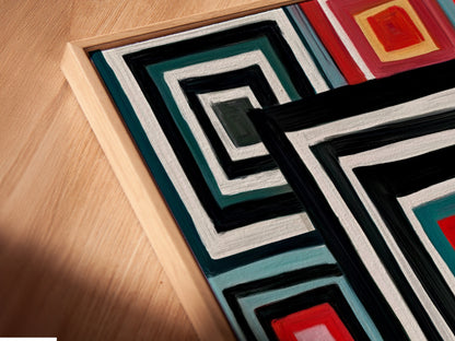A close-up angled view of a Geometric Squares canvas print in a floating frame. The retro colorful wall artwork enhances any space. Its modern abstract elements bring a unique touch to your home decor. Get this bold graphic print for your wall.