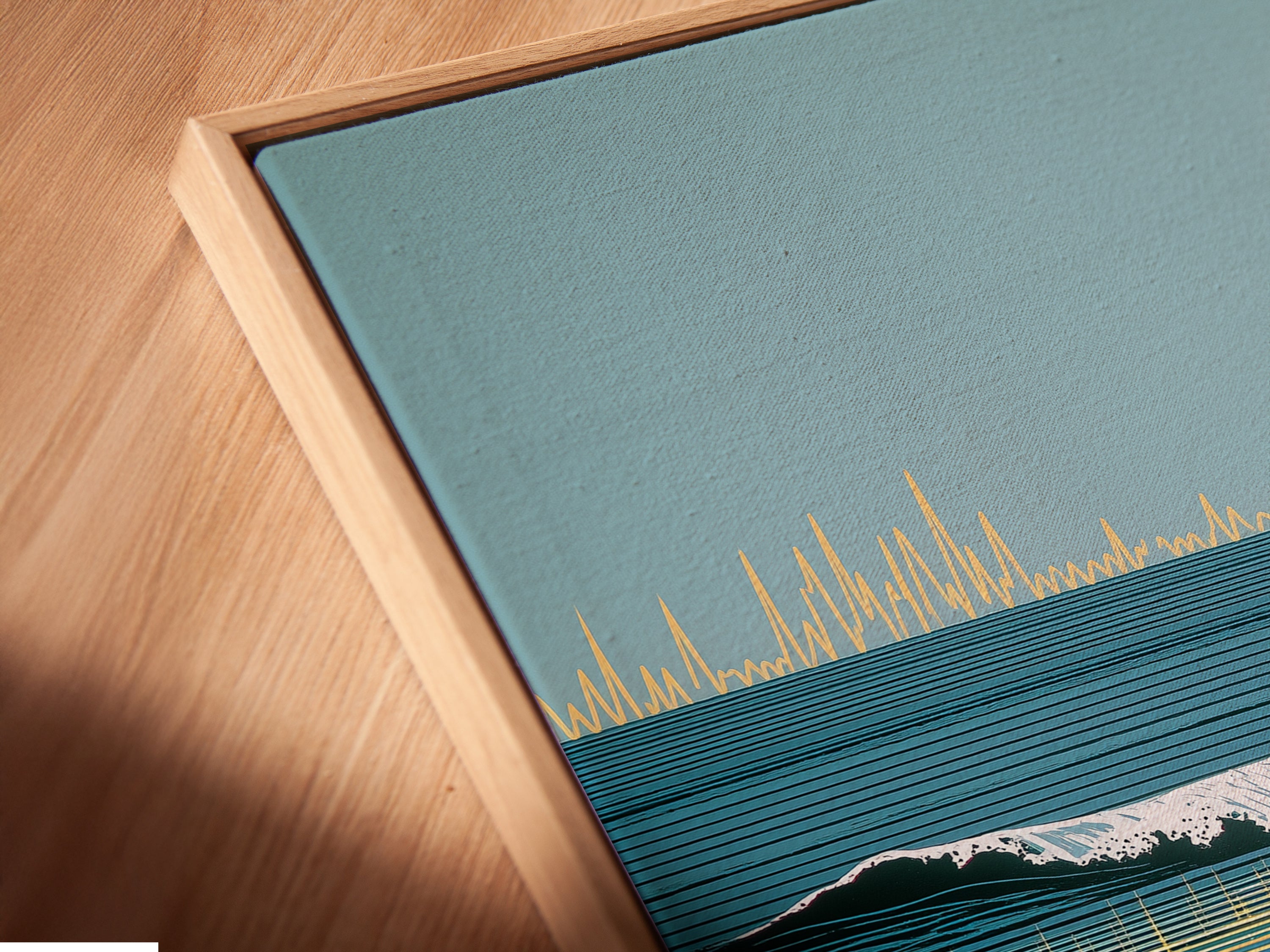 A close-up of a canvas print in a floating frame. The ocean sunset artwork features a surreal wave illustration. This framing style adds depth and sophistication. Perfect for modern coastal wall art and beach artwork