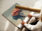 A woman is carefully rolling a fine art poster paper. The paper displays a surreal double exposure artwork. It features a woman silhouette a moon and a tree. This high-quality print ensures lasting beauty and detail.