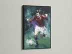 A soccer player canvas art piece with an abstract sports theme is displayed in a black frame. The artwork is a dynamic action painting. This sports wall art will enhance living rooms bedrooms offices or man caves. The black frame adds a modern touch.