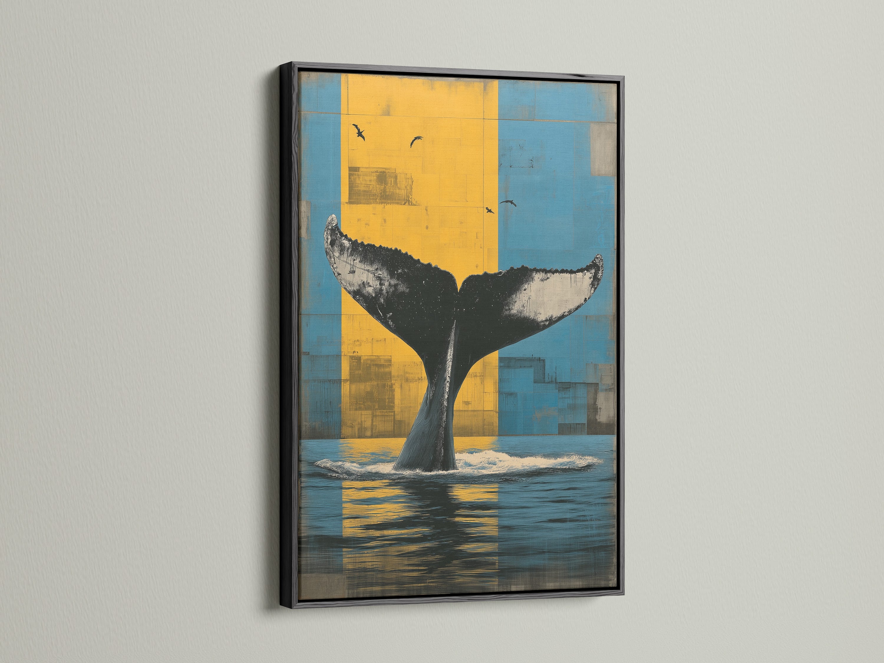 Whale Tail art in a black frame. This contemporary art piece shows a whale tail. The artwork is set against blue and yellow tones. This ocean canvas is great for any room. Add a nautical theme with this marine life print.