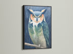This striking owl portrait canvas print is set in a black frame. The moody bird wall art creates a focal point in any room. Teal and beige tones enhance the animal artwork. Great addition to a study room or library wall decor.