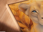 A close-up of Lioness Portrait Canvas Art. The artwork is displayed in a floating frame. This contemporary art piece is perfect for any room. The floating frame adds a touch of elegance. Discover this unique piece of wildlife art today