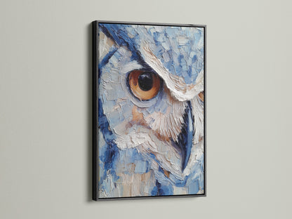 Owl artwork displayed in a sleek black frame. The artwork's intricate details are accentuated by the dark frame. The piece is characterized by its textured painting style. The color palette consists of blues and whites. The owl's intense stare is captivating.