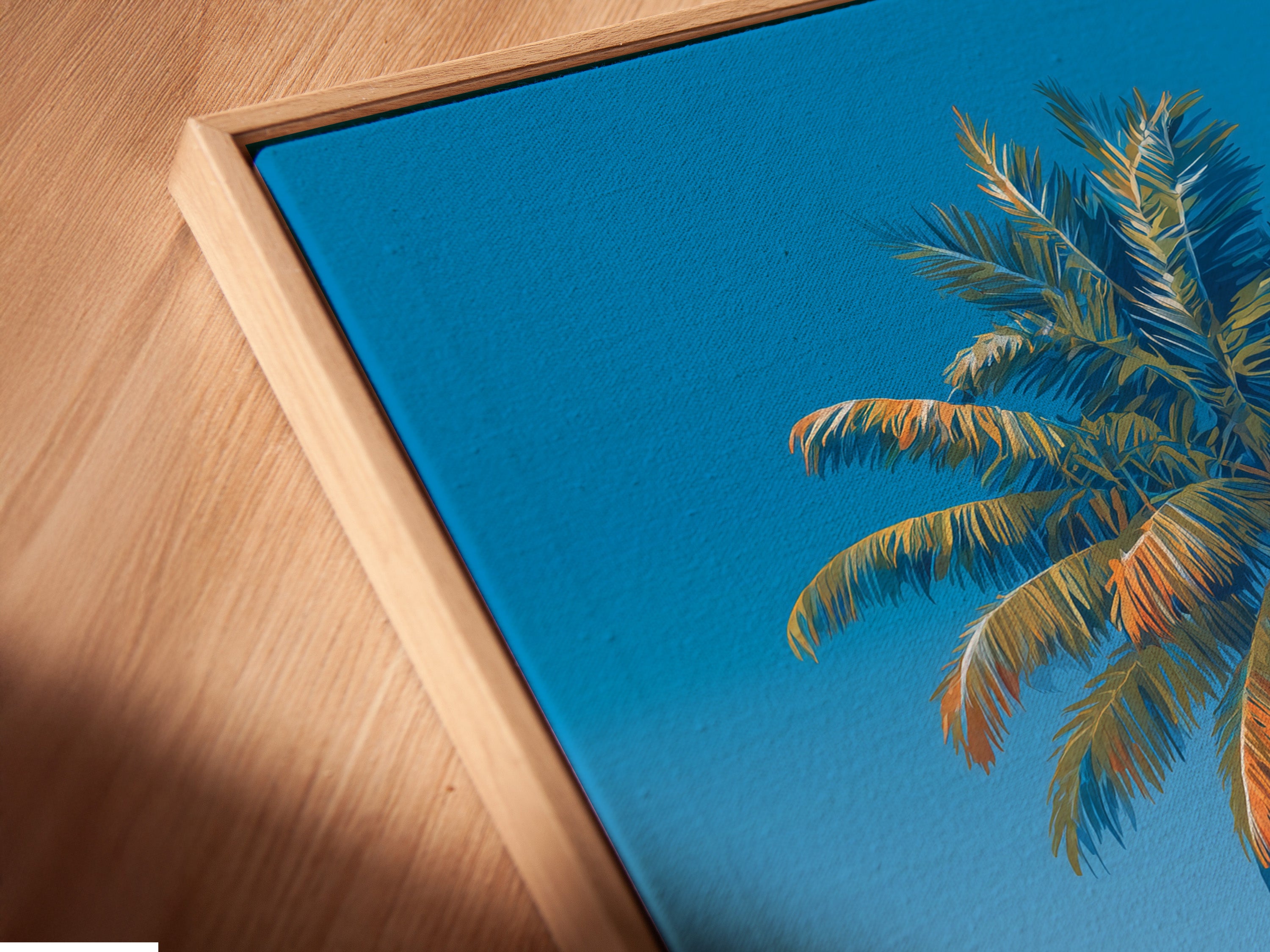 This is a close-up angled view of a canvas print in a floating frame. See the intricate details of the tropical wall art. The beach ocean artwork adds depth and dimension. The floating frame enhances the overall aesthetic. Perfect for creating a focal point in your living space