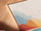 A close-up of a canvas print in a floating frame. The coastal marsh artwork showcases a beautiful sunset seascape. The modern teal and coral colors add depth and dimension. Perfect for a minimalist or Scandinavian interior.