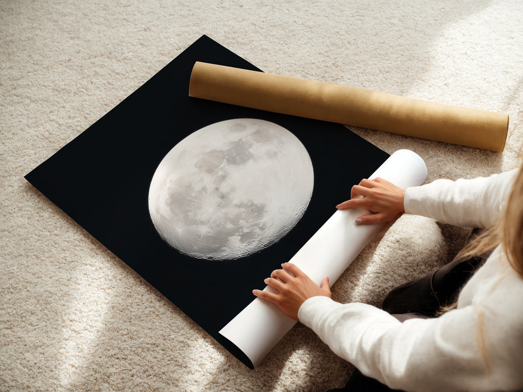 A woman rolling a Full Moon fine art poster paper. She is preparing celestial art for astronomy decor. She is creating moon phase art for your home. This is perfect space themed art. It's a unique astrology gift. This will become a night sky print. This is a beautiful piece of full moon artwork and a celestial print.