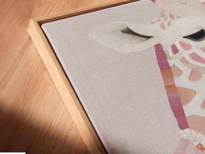 Angled close up reveals a canvas print in a floating frame. Pink blush animal wall art adds a modern touch. The fashion giraffe with pearls stands out beautifully. Floating frame enhances this nursery decor. Chic animal art for any space.