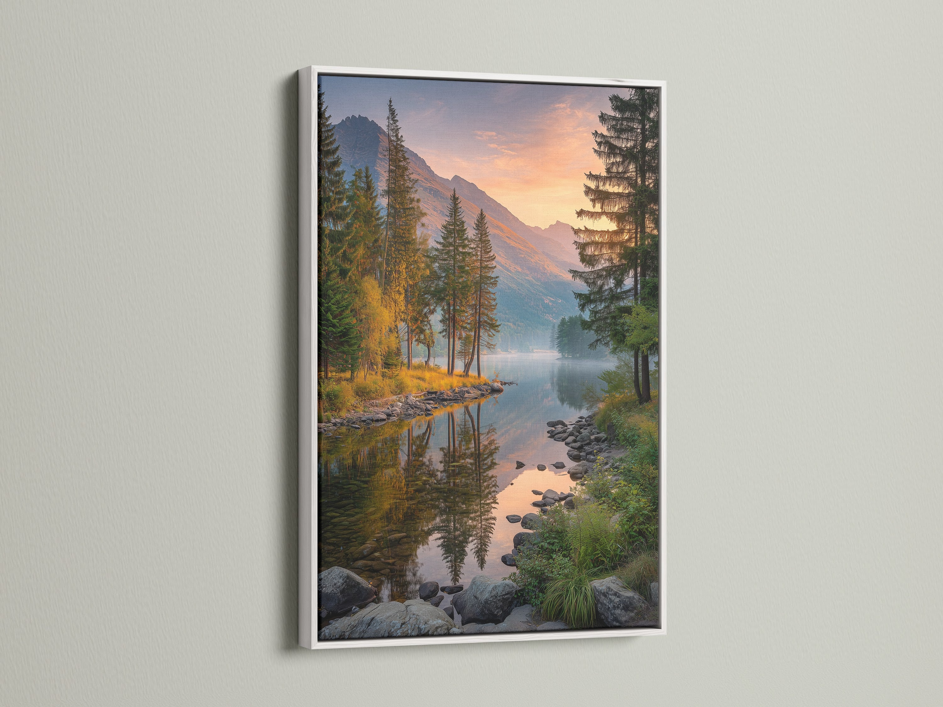 A white frame highlights a stunning mountain lake canvas print. This landscape art features a tranquil nature scene. The pine tree artwork is perfect for creating a calming atmosphere. Enhance your cabin decor with this nature canvas. Ideal for adding a touch of serenity to your living room or bedroom.