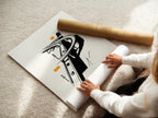 A woman carefully rolls a fine art poster paper. The paper showcases the Highway Overpass artwork. This urban minimalist print is perfect for modern decor. The black and white cityscape design adds sophistication. Ideal for architects and urban professionals. Enhance your space with this artwork.