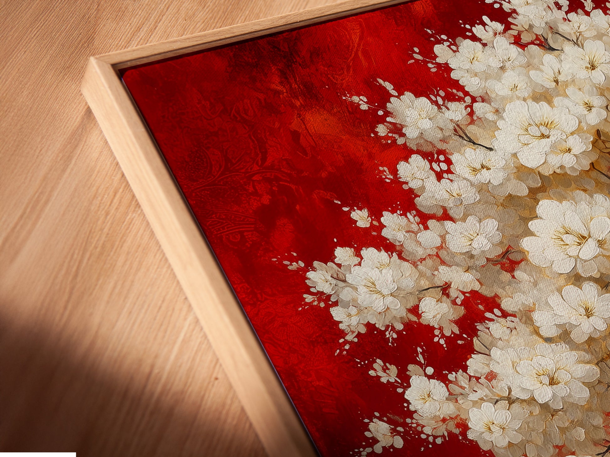 An angled close-up reveals a canvas print in a floating frame. The cherry blossom tree artwork is highlighted with its vibrant red and gold colors. The Japanese bonsai canvas wall art is perfect for adding a touch of Asian home decor. This oriental wall art enhances the beauty of any room.