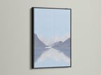 Artwork is elegantly framed in black. The black frame provides a classic contrast. The artwork illustrates a calming lake and mountain view. The black frame enhances the artwork's depth and detail. Ideal for adding a touch of sophistication to your space.