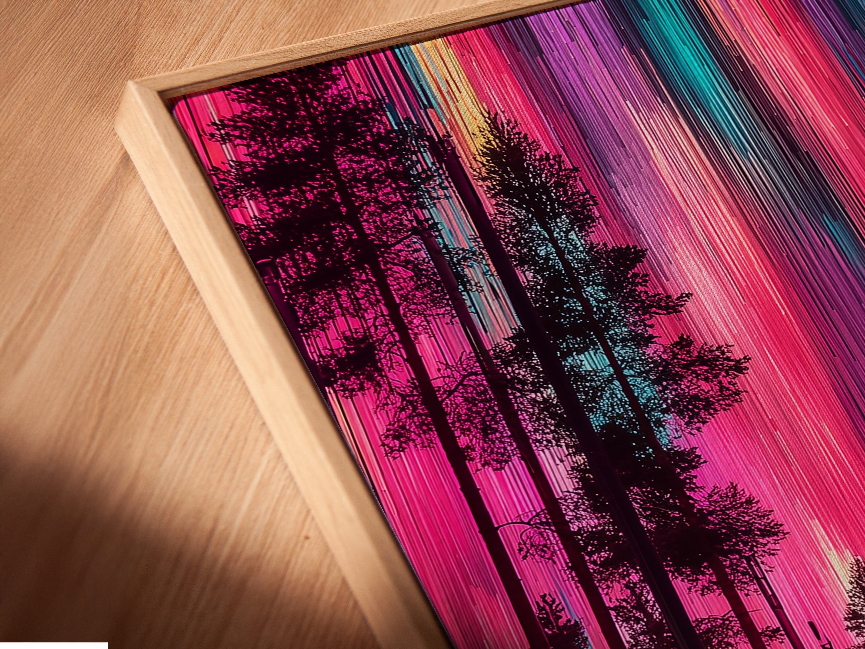 Close-up angled view of an Aurora Borealis canvas print. The artwork is set in a floating frame. The colorful forest poster creates vivid wall decor. Perfect for adding a touch of Scandinavian style to your space. A beautiful nature print.
