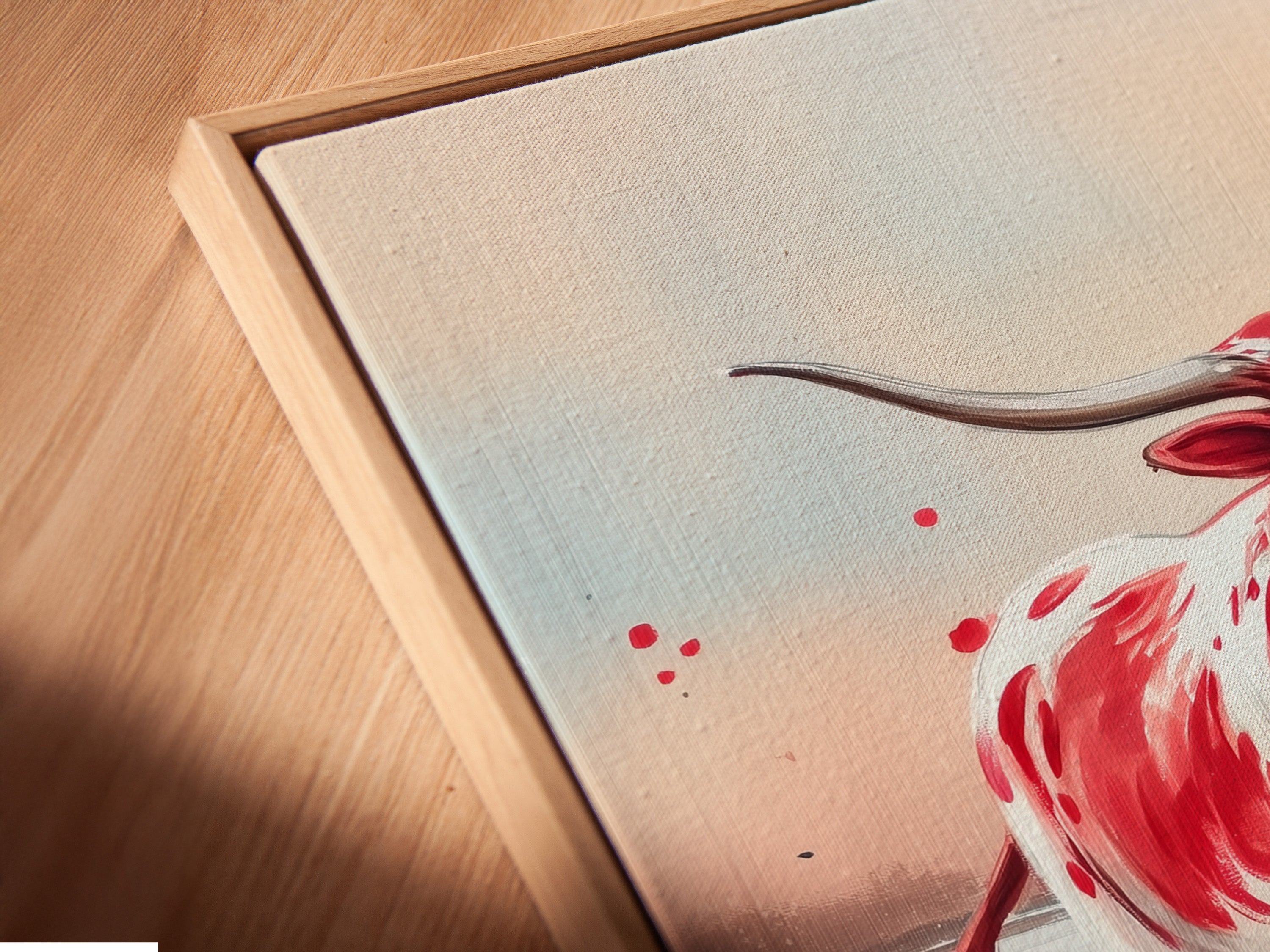 A close-up of Texas Longhorn canvas art in a floating frame. The artwork highlights the vibrant colors of the Longhorn and wildflowers. This piece enhances any farmhouse or country-style decor. Perfect for a rustic touch.