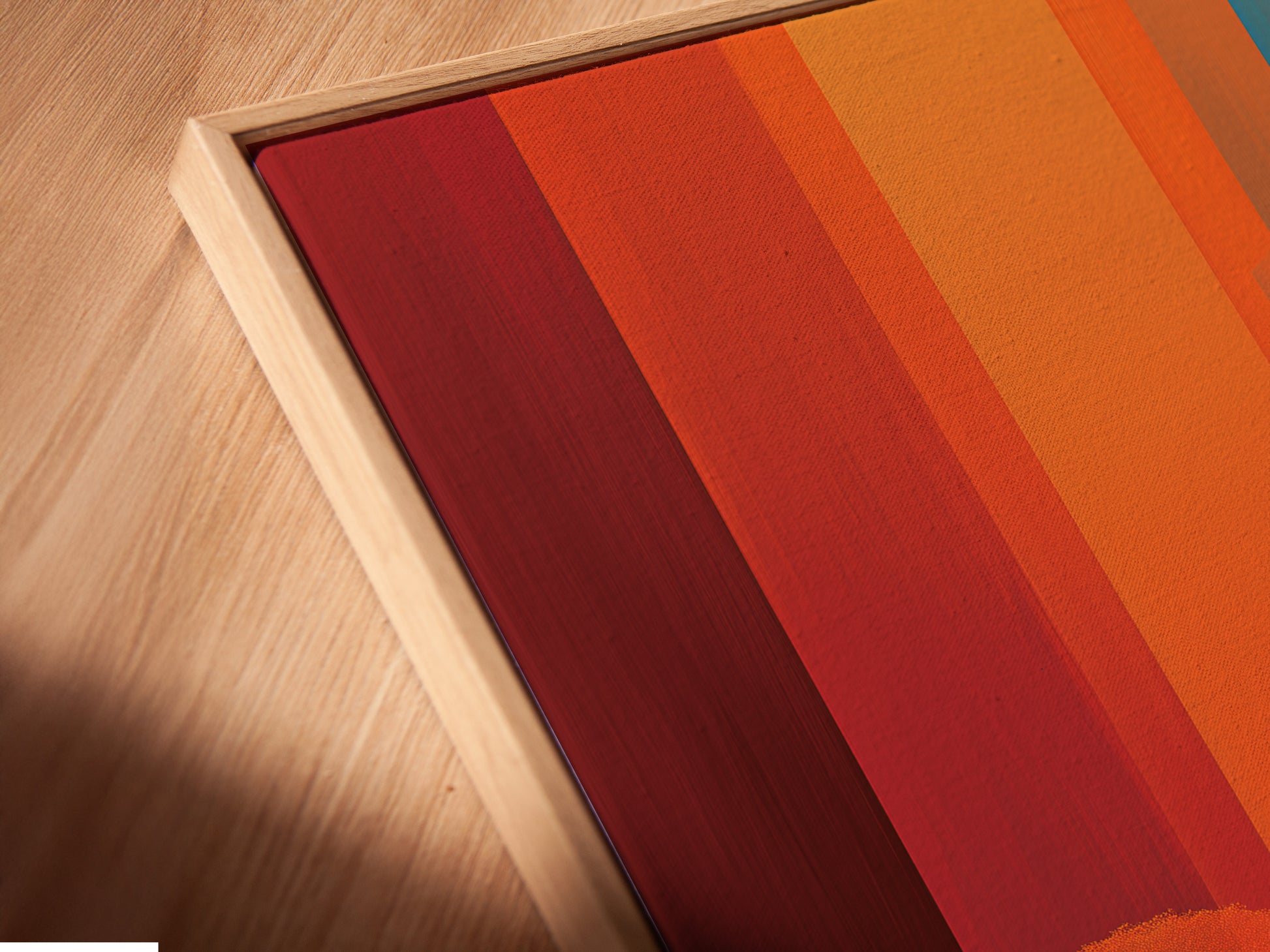A close-up angled view of a canvas print. The artwork is displayed in a floating frame. The surreal landscape features a modern abstract style.  Orange and teal colors enhance this minimalist figure poster.