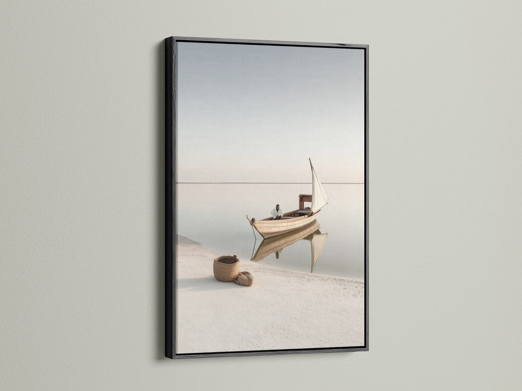 Seascape Wall Art in a black frame. This striking nautical decor brings a bold touch to your walls. The black frame contrasts beautifully with the beige tones of the coastal artwork. A modern take on seaside prints.