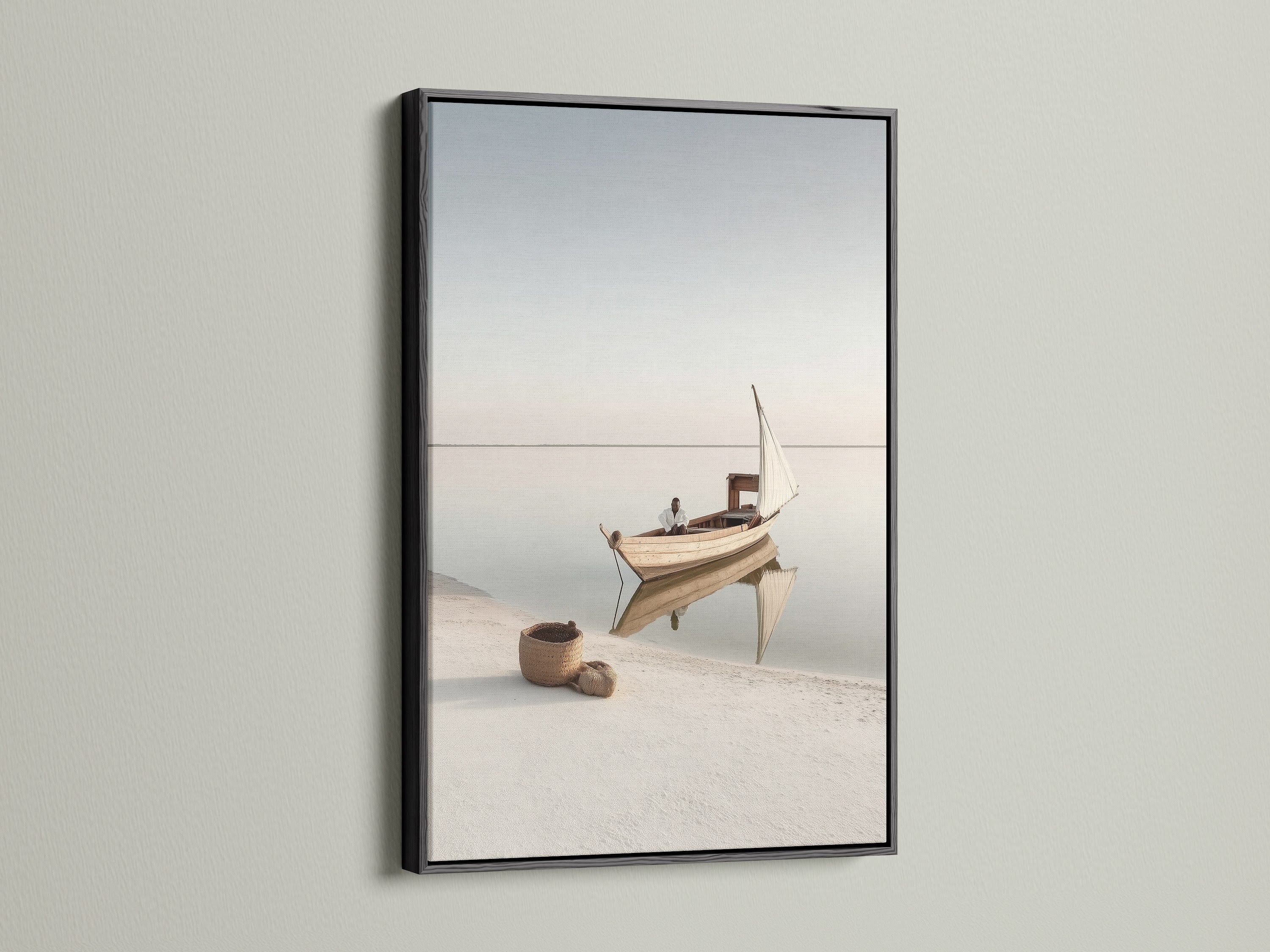 Seascape Wall Art in a black frame. This striking nautical decor brings a bold touch to your walls. The black frame contrasts beautifully with the beige tones of the coastal artwork. A modern take on seaside prints.