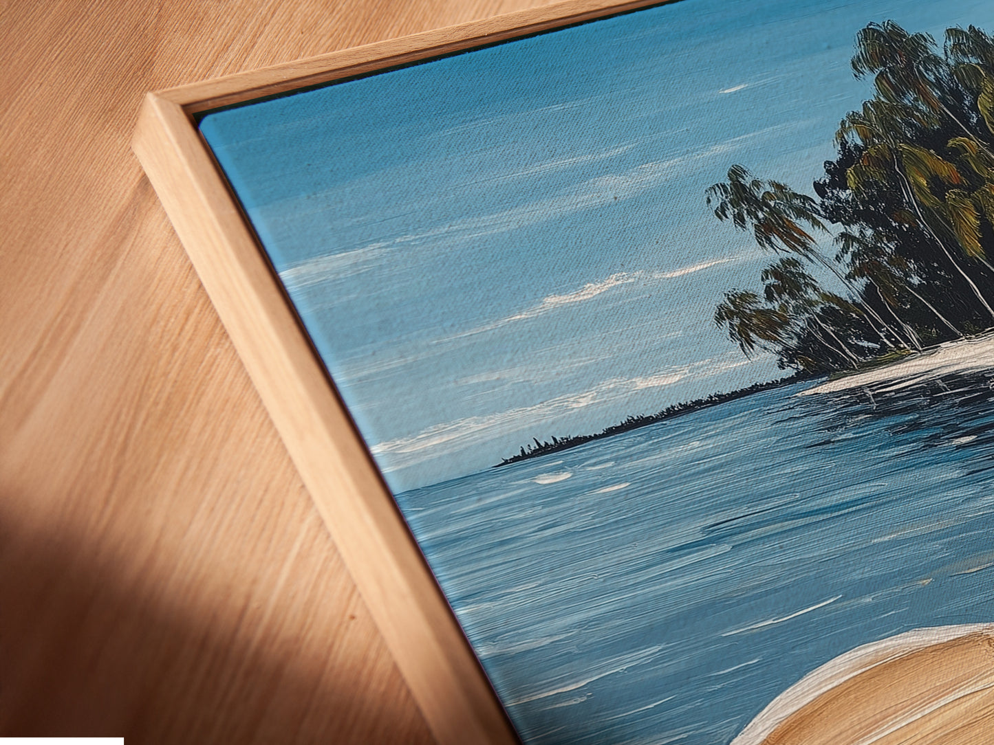 Close-up of a canvas print in a floating frame. This tropical beach artwork features a white boat. The coastal wall art is perfect for any room. The seascape painting adds a serene touch. Discover our range of beachy home decor and nautical artwork.