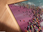 Angled close up of a canvas print in a floating frame. The artwork features an orange Volkswagen van on a beach with a crowd of people. The floating frame enhances the artwork's presentation. Perfect for adding a retro touch to your wall decor.