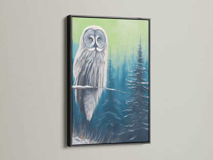 Owl canvas print with a black frame. The contrast of the black frame makes the artwork pop. The owl is perched in a blue and green snowy forest. A striking piece of animal artwork for your home.
