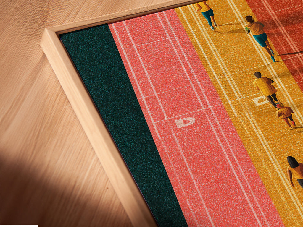 Close-up of a canvas print in a floating frame. The running track artwork brings energy to any room. This aerial sports wall art is perfect for home gym decor. A stylish and motivational piece.