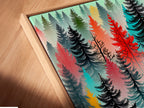 Angled close up of a canvas print in a floating frame. The colorful forest artwork is vibrant and eye-catching. This abstract tree wall art enhances any room. The modern woodland print features red turquoise and black trees. Perfect for adding scandi decor to your home. This tree canvas is ideal for bedroom art.