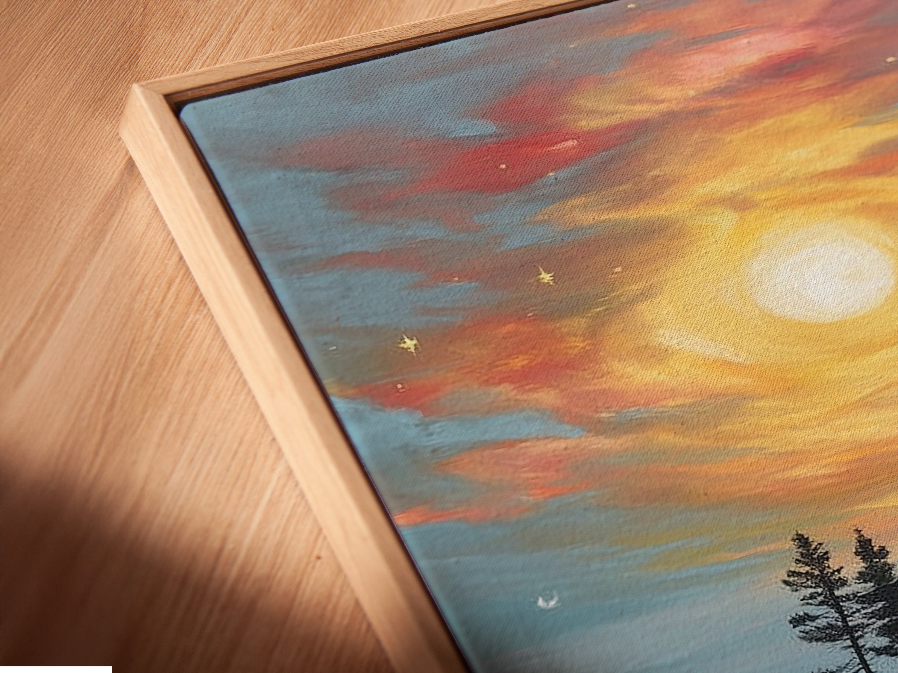 Close-up angled view of a Lake Sunset Canvas Print in a floating frame. The artwork captures a tranquil island landscape. The floating frame adds a modern touch to this warm tone nature artwork. It is a perfect piece for any room.