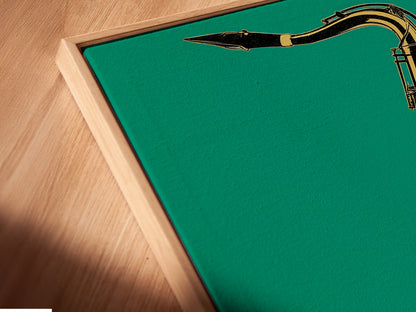 A close-up of a saxophone canvas print in a floating frame. The teal green background makes the gold saxophone stand out. This modern wall art is perfect for any music lover. The floating frame adds a touch of elegance. Transform your space with this jazz instrument art.