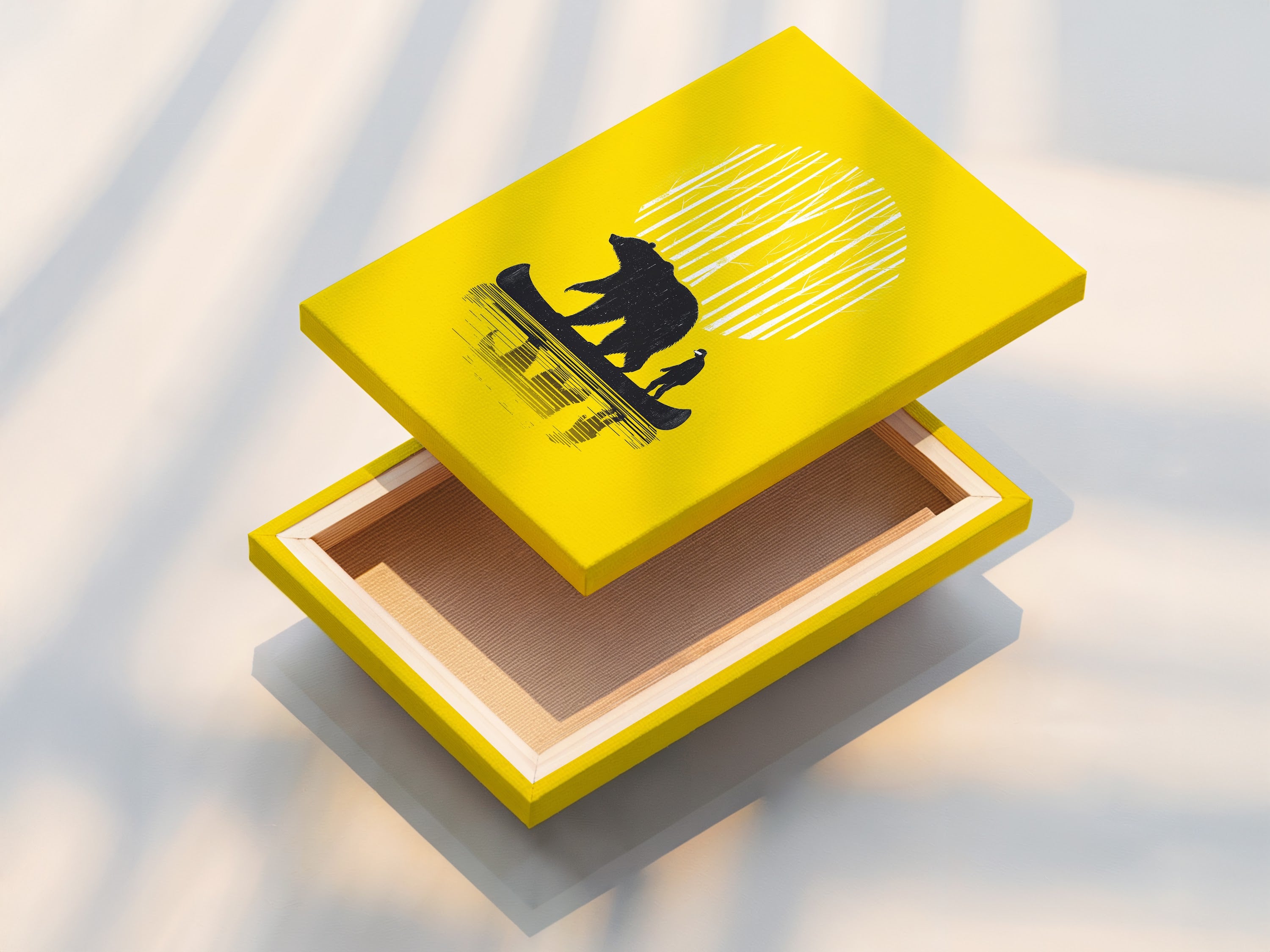 A stretched canvas print of the Bear Canoe artwork. The art features a bear and man in a canoe. The stretched canvas print is ready to hang in your home. It is great for cabin decor or woodland decor.