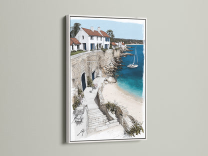 Coastal Village artwork in a white frame. The artwork depicts a charming seaside scene. The white frame accentuates the bright blues of the sea. White buildings are perched along the coastline. This artwork offers a fresh and airy feel. Perfect for minimalist Scandinavian coastal styles.