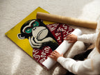 A woman carefully rolling a fine art poster paper of a monkey artwork. The vibrant pop art primate canvas art is ready for display. This animal wall decor is perfect for modern spaces. The fine art poster paper ensures high-quality print. Add a touch of playfulness with this quirky wall decor. Ideal for students and young professionals.