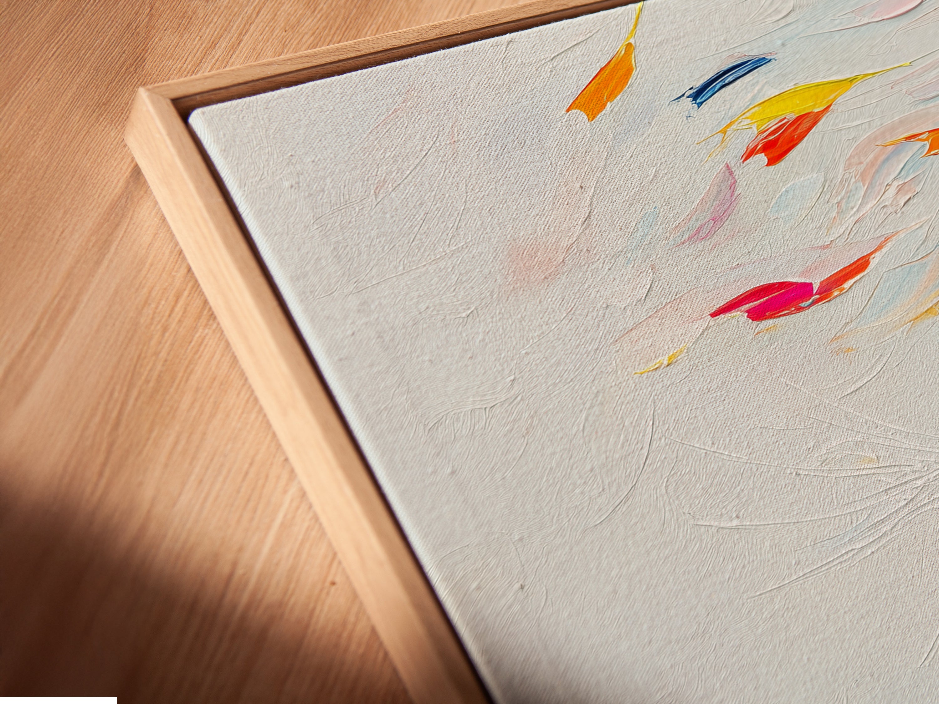 An angled close-up shows a canvas print in a floating frame. The colorful cat artwork brings an abstract touch. The vibrant rainbow feline artwork is perfect for bedroom decor. It adds a modern and playful style to any space. It is a great choice for contemporary wall art.