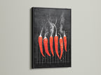 A red hot chili pepper artwork is framed in black. The art is displayed on a clean white wall. The artwork adds a bold and modern touch to culinary spaces. Perfect as restaurant art or spicy food decor. It is ideal for those seeking minimalist artwork.