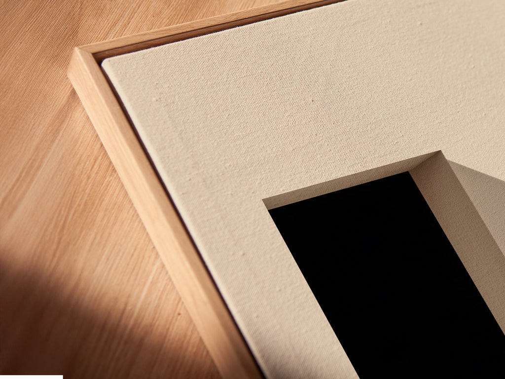 A close-up angled view of a stone canvas print in a floating frame. The artwork features minimalist geometric shapes. Neutral colors create a calming zen atmosphere. This modern wall decor is perfect for any space. The floating frame enhances the artwork's contemporary style. Add a touch of simple elegance to your home or office.