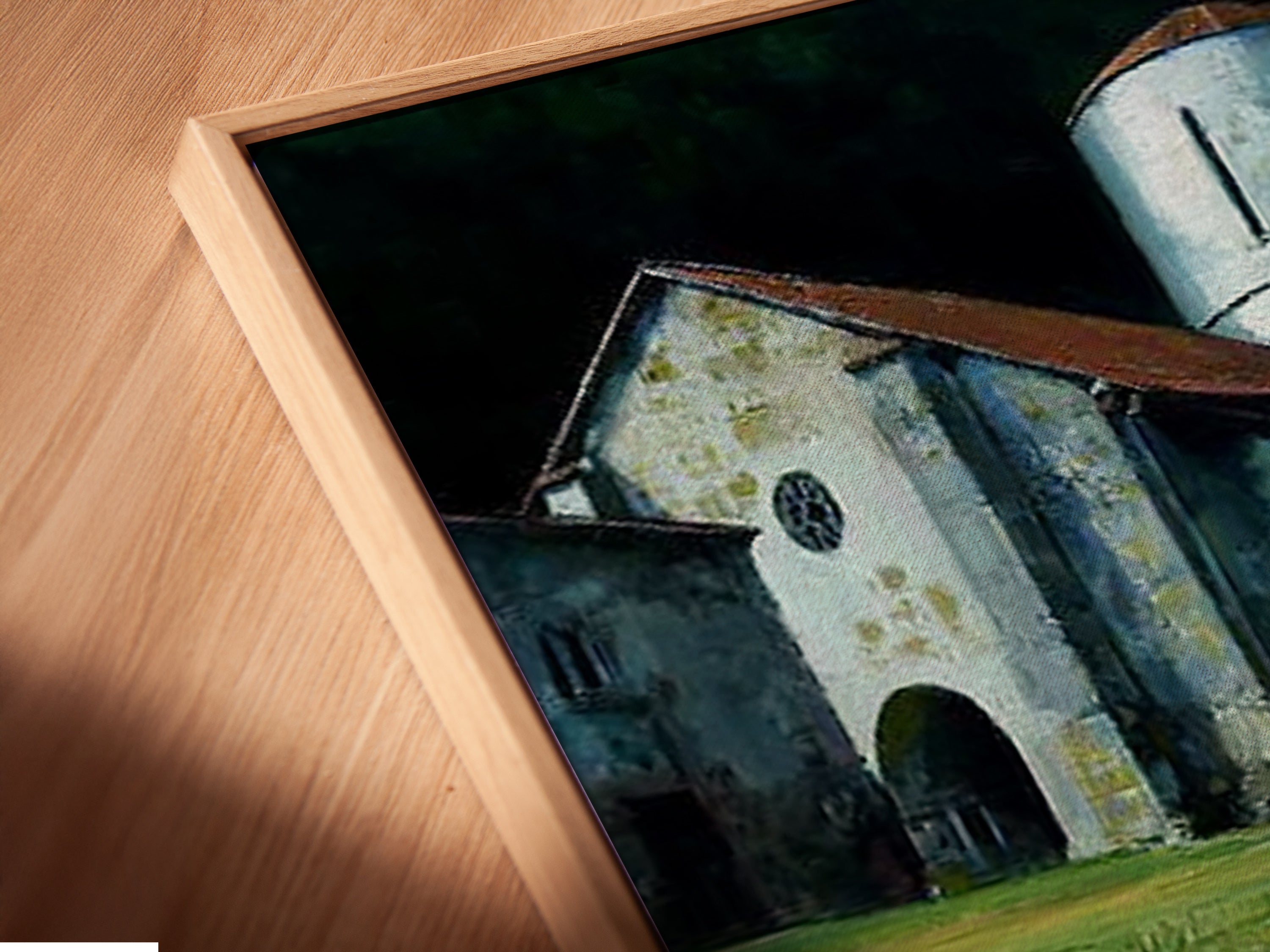 A close-up of a canvas print in a floating frame. The church tower artwork adds a vintage touch. The rustic style is perfect for any room. The architectural art enhances your home decor. The stone path is visible