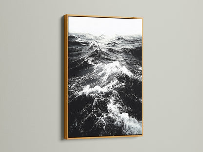 A gold frame displays black and white ocean wave artwork. The metallic finish adds a touch of elegance. Ideal for sophisticated coastal wall art. Perfect for a beach house decor. Browse our wave artwork now.
