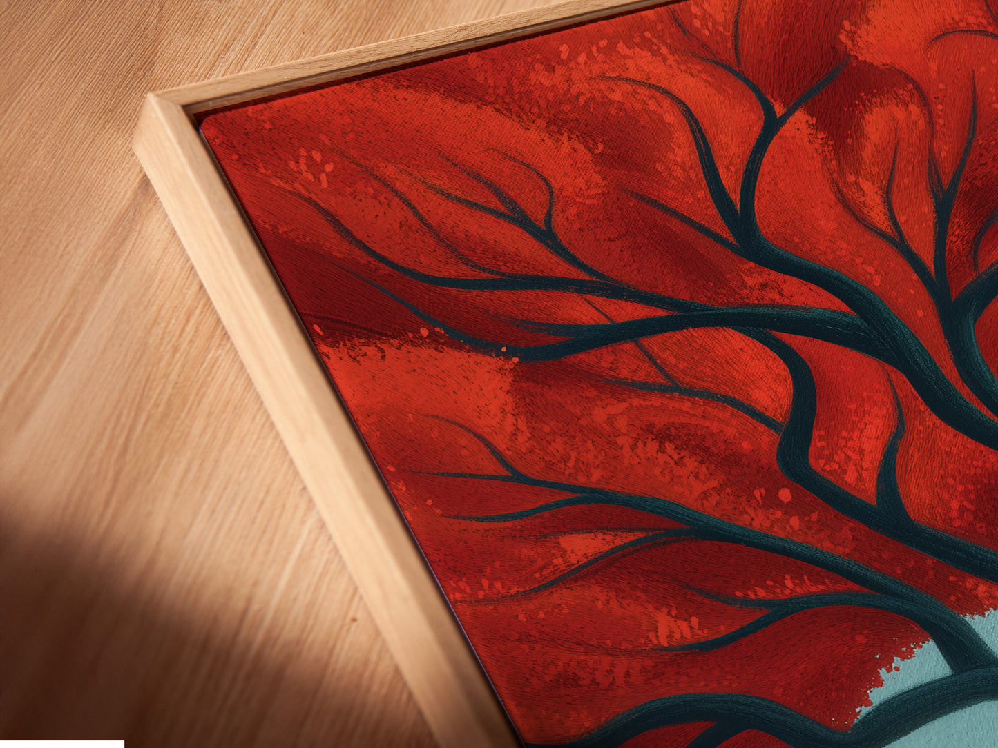 A close-up angled view shows a canvas print in a floating frame. The Red Tree coastal landscape artwork looks amazing. The floating frame adds depth and dimension. It is perfect for living room art or bedroom wall art.