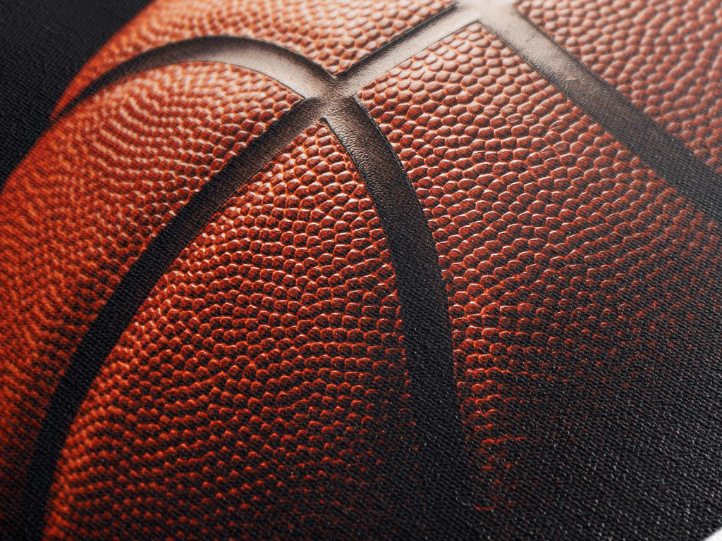 Close up view of a textured canvas print of a basketball